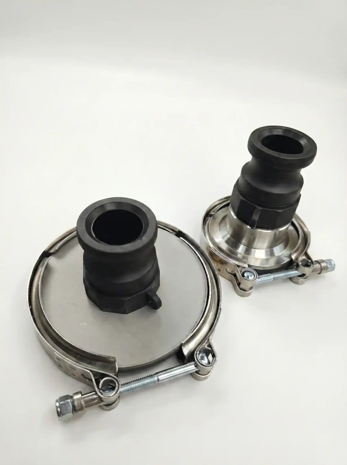 Two black camlock adapters with stainless V-band clamps from the Euro 6+ adapter kit