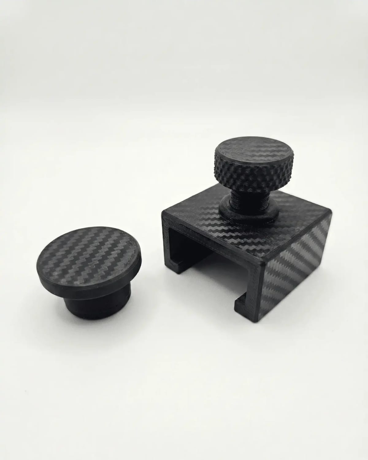 A black printed AdBlue blanking plug and clamp for Ford Euro 6 filters