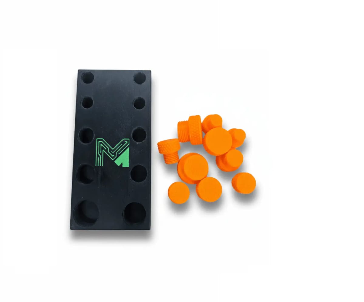 A black magnetic stand with orange knurled threaded plugs