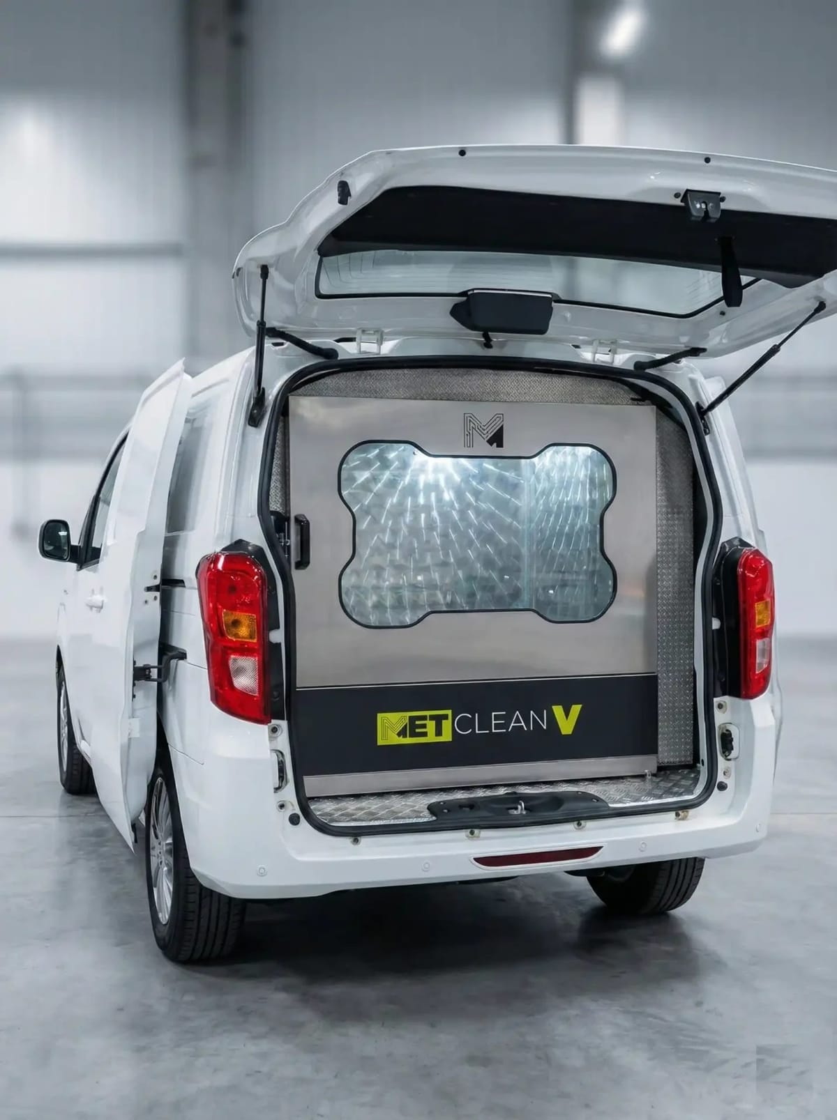 METClean V installed in the back of a white van, seen through the open tailgate