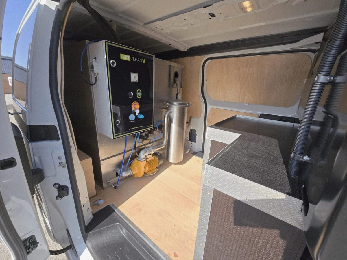 METClean V control panel, pump and filter housing fitted inside a van, seen through the side door