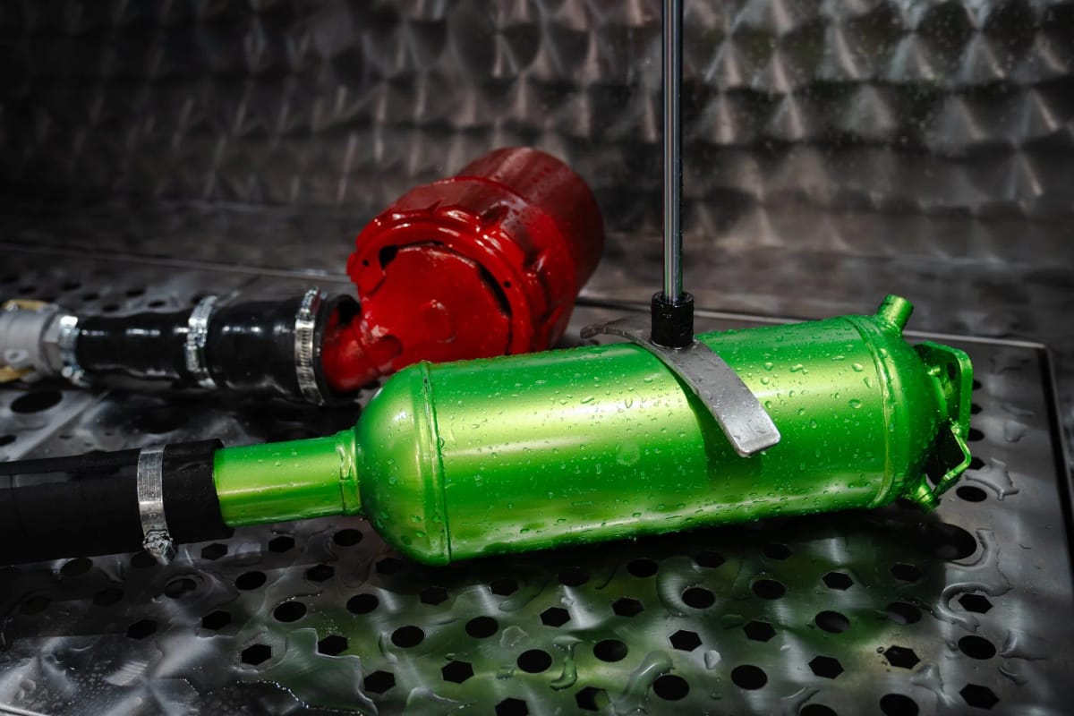 Two exhaust components clamped and connected on the floor of a METClean XL chamber